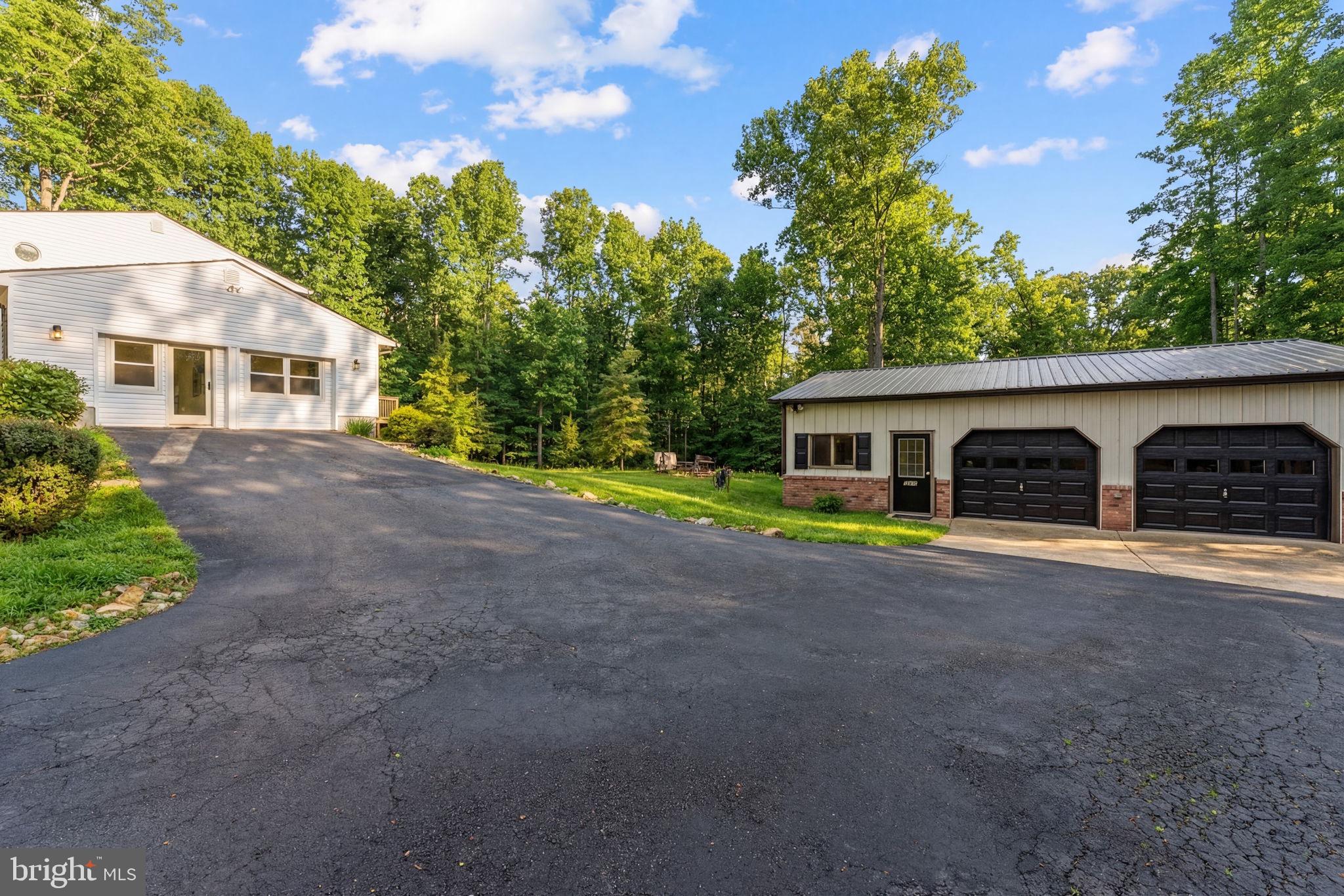 2266 Beaver Dam Road Midland, VA 22728 - Photo 10 of 93 a front view of a house with a garden and trees