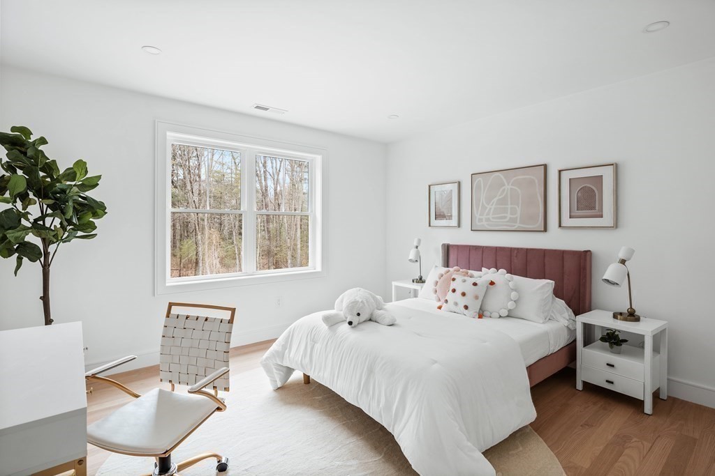 5 Brookside Lane Burlington, MA 01803 - Photo 26 of 40 a bedroom with a bed and a potted plant