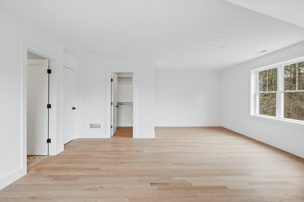 5 Brookside Lane Burlington, MA 01803 - Photo 31 of 40 a view of empty room with wooden floor and windows