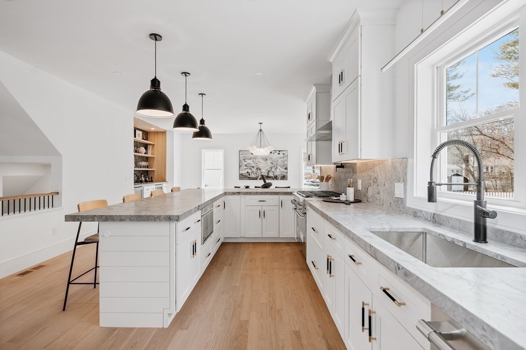 5 Brookside Lane Burlington, MA 01803 - Photo 10 of 40 a large white kitchen with granite countertop a sink and cabinets