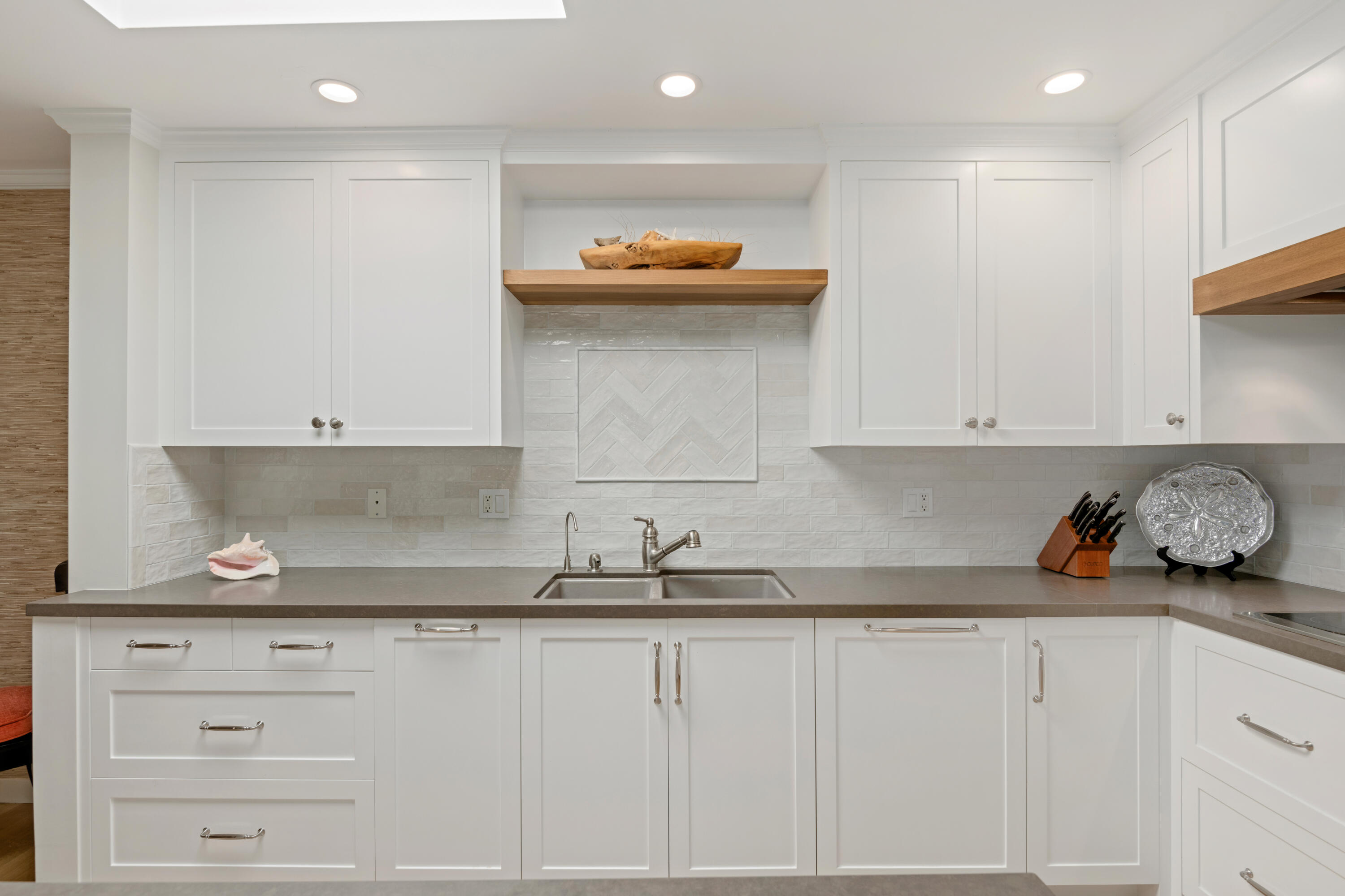 1220 Coast Village Road, Unit 303 Santa Barbara, CA 93108 - Photo 7 of 29 a kitchen with granite countertop white cabinets and a sink