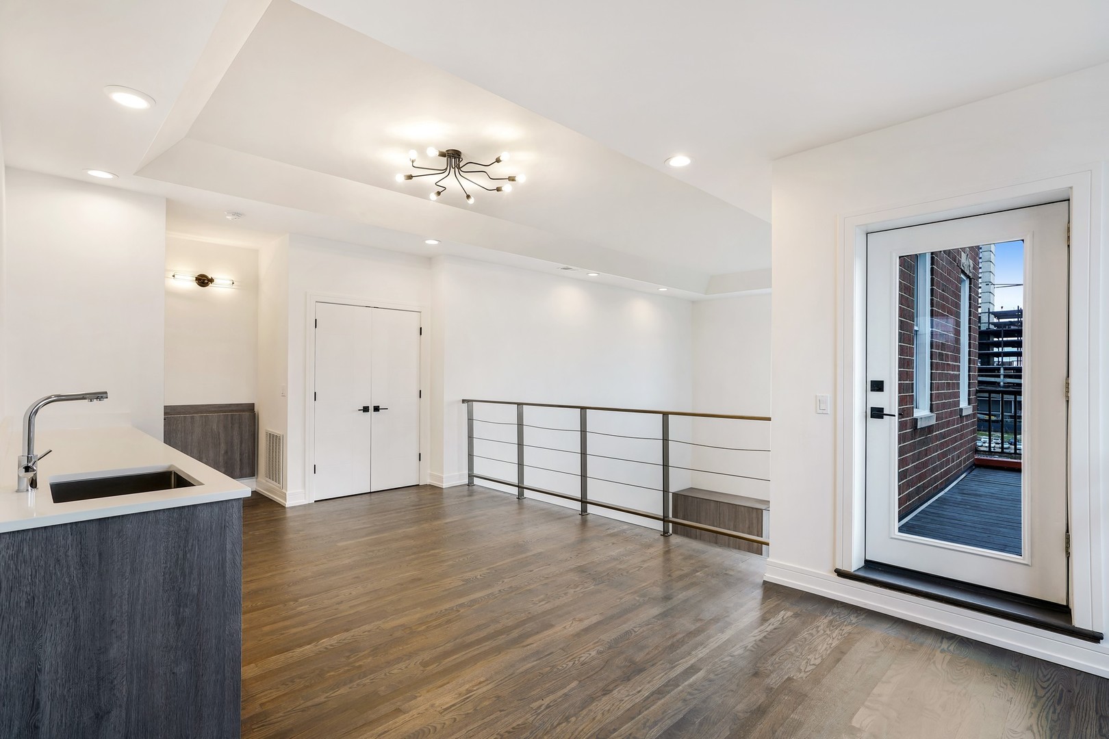 822 West Hubbard Street, Unit 5 Chicago, IL 60642 - Photo 12 of 31 a view of an empty room with wooden floor and a window