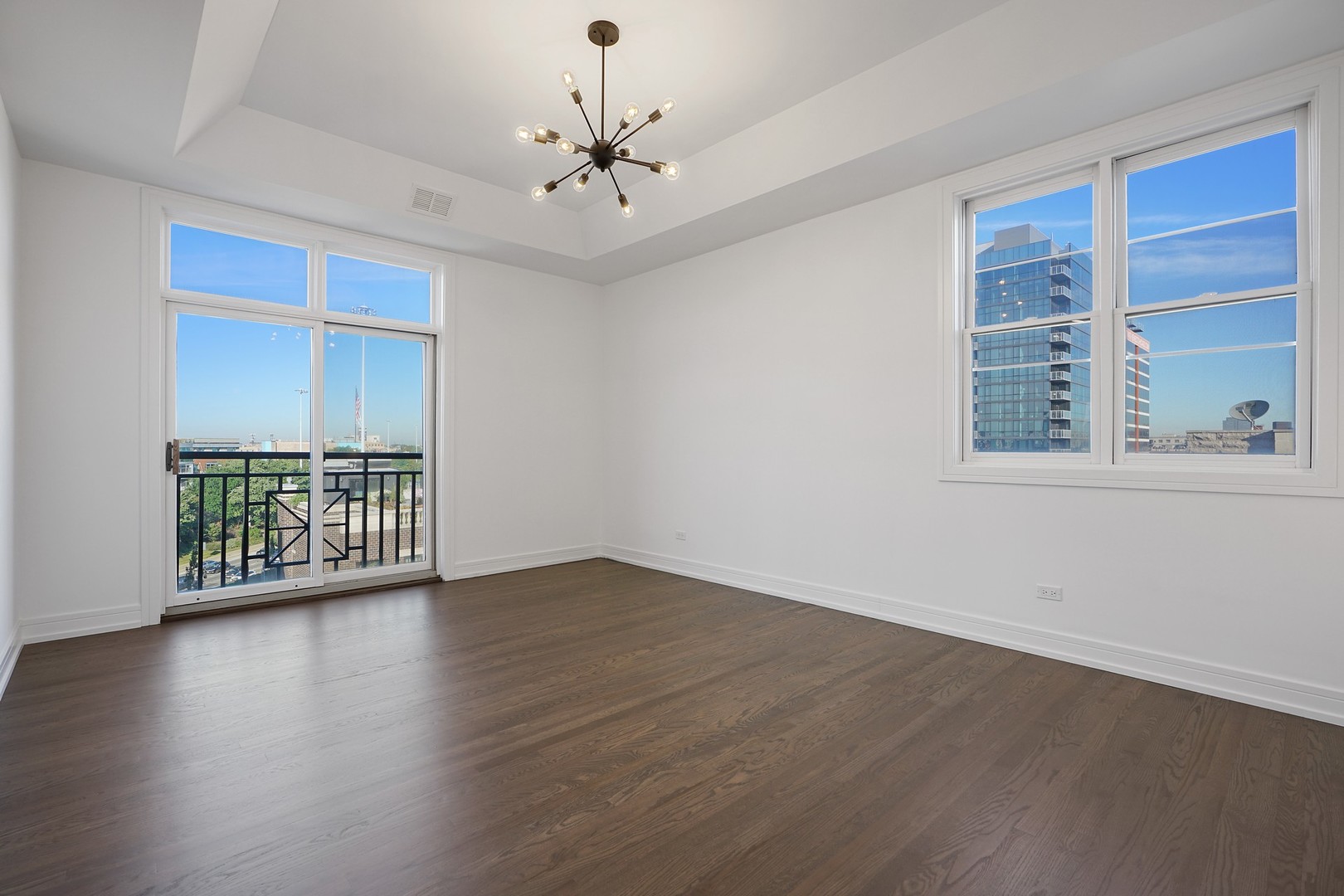822 West Hubbard Street, Unit 5 Chicago, IL 60642 - Photo 14 of 31 a view of an empty room with wooden floor and a window