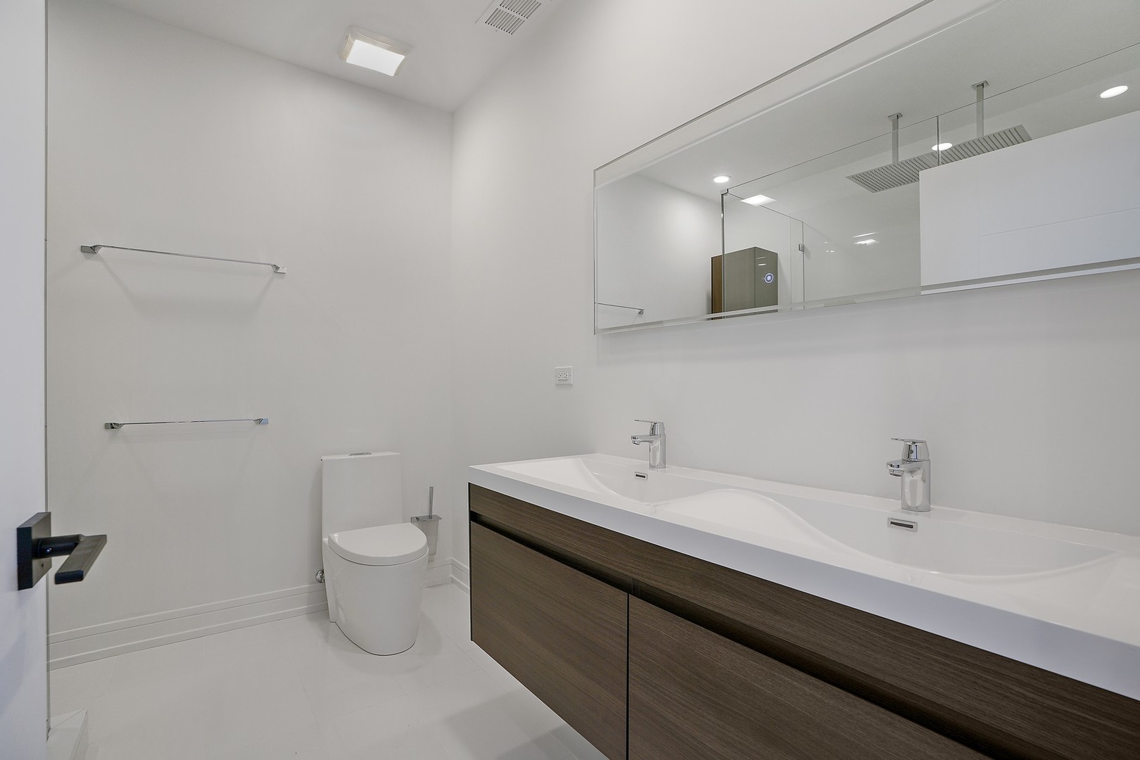 822 West Hubbard Street, Unit 5 Chicago, IL 60642 - Photo 16 of 31 a bathroom with a double vanity sink toilet and a mirror