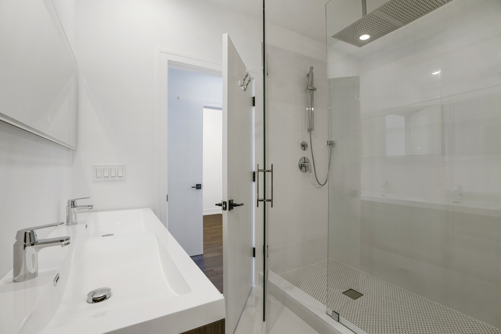 822 West Hubbard Street, Unit 5 Chicago, IL 60642 - Photo 17 of 31 a bathroom with a shower sink vanity and mirror