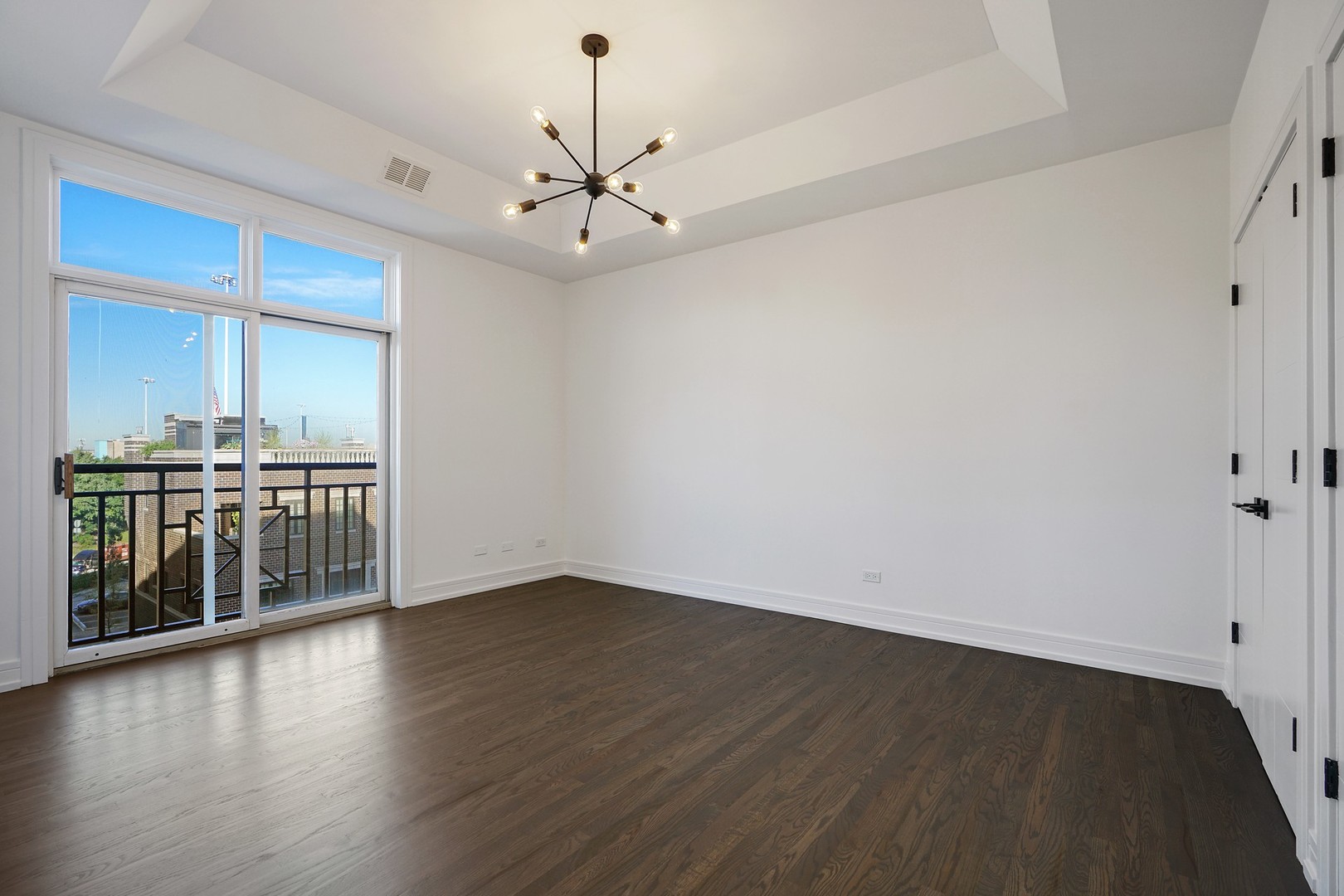 822 West Hubbard Street, Unit 5 Chicago, IL 60642 - Photo 18 of 31 an empty room with wooden floor chandelier and windows