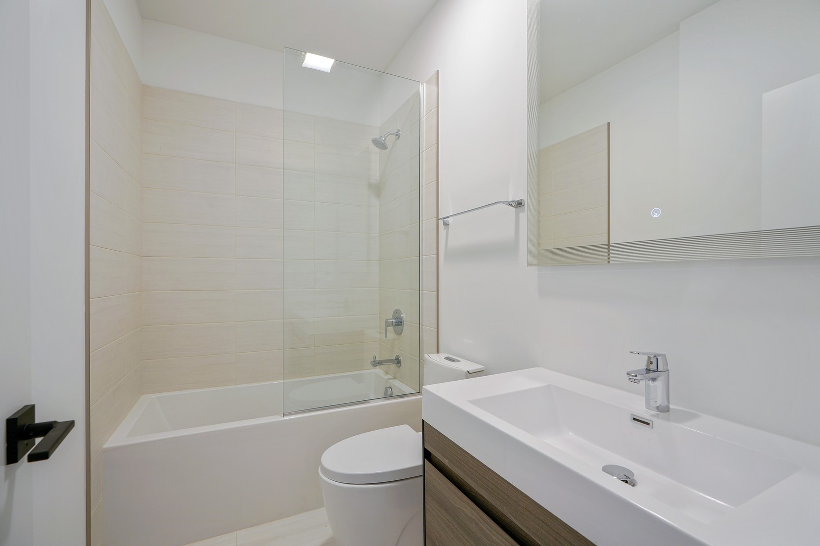 822 West Hubbard Street, Unit 5 Chicago, IL 60642 - Photo 19 of 31 a bathroom with a sink toilet and shower