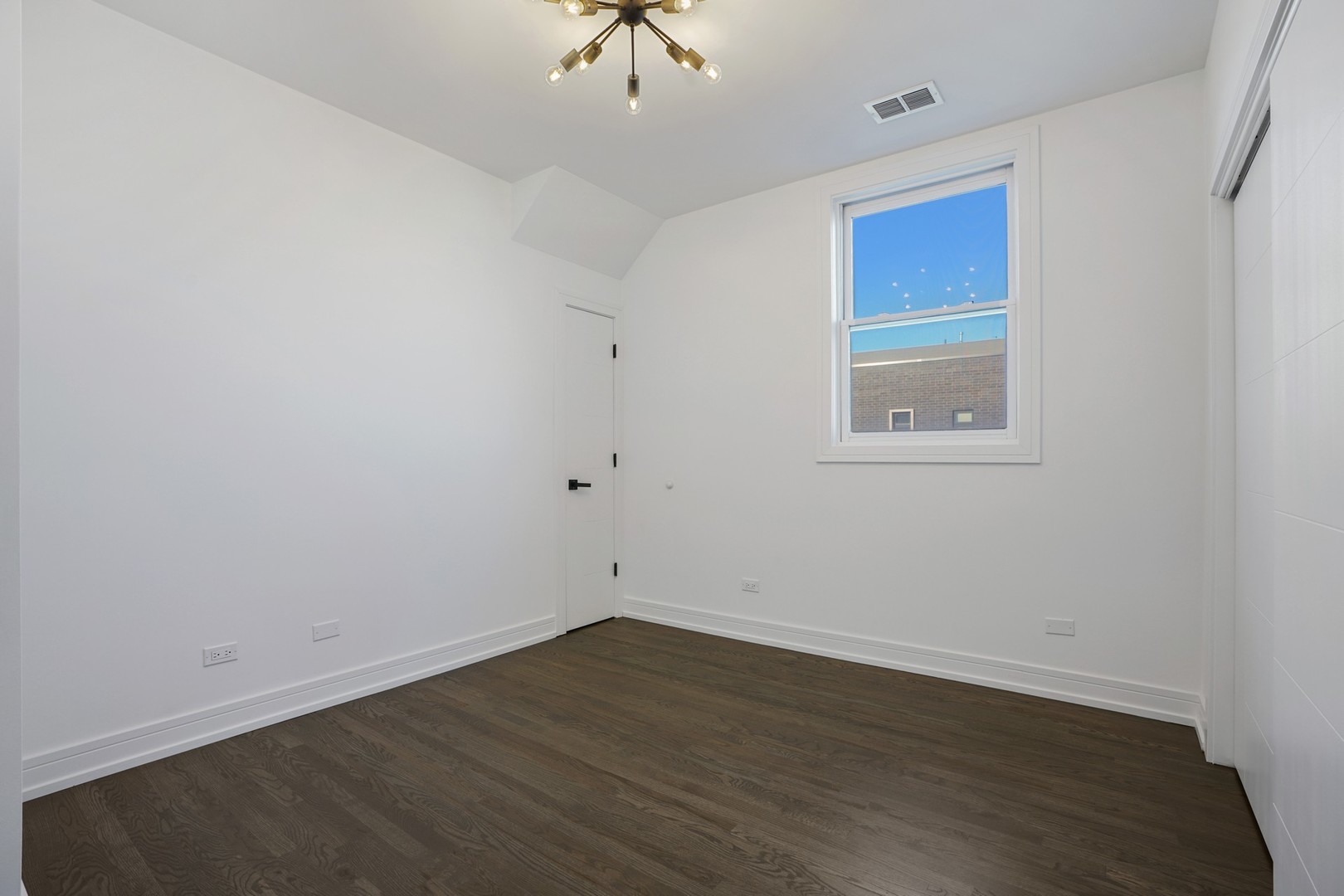 822 West Hubbard Street, Unit 5 Chicago, IL 60642 - Photo 20 of 31 an empty room with wooden floor and windows