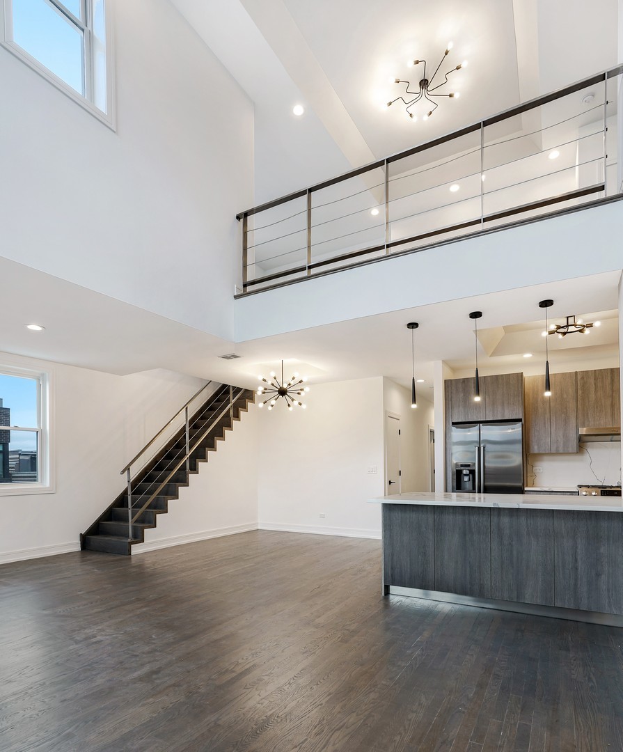 822 West Hubbard Street, Unit 5 Chicago, IL 60642 - Photo 3 of 31 a view of a living room and kitchen with wooden floor