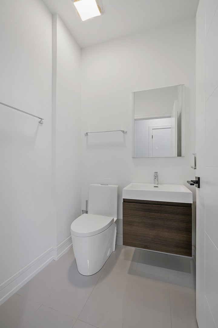 822 West Hubbard Street, Unit 5 Chicago, IL 60642 - Photo 21 of 31 a bathroom with a sink and a mirror