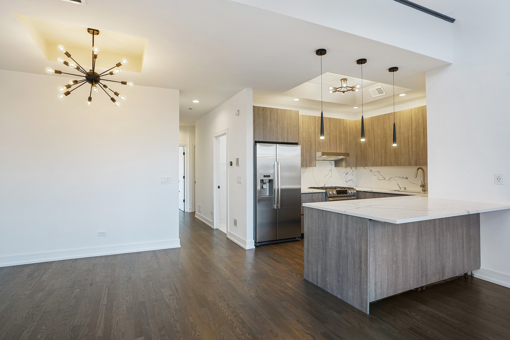 822 West Hubbard Street, Unit 5 Chicago, IL 60642 - Photo 5 of 31 a kitchen with stainless steel appliances a chandelier and wooden floor