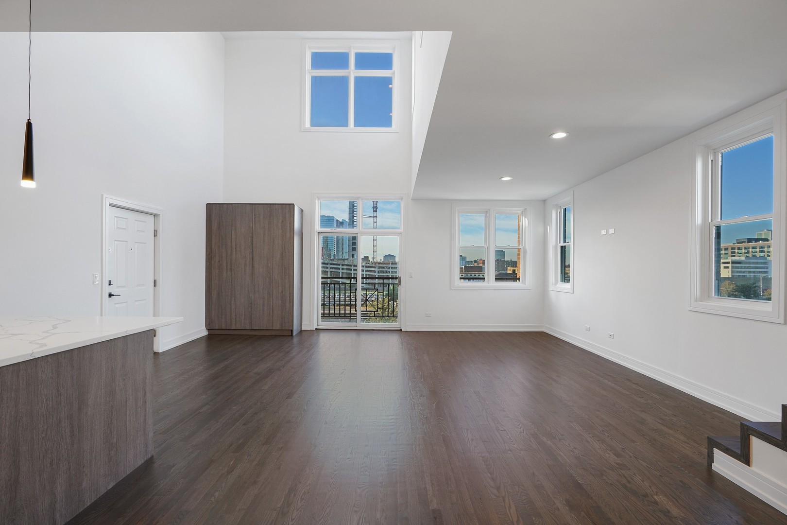 822 West Hubbard Street, Unit 5 Chicago, IL 60642 - Photo 8 of 31 a view of an empty room with a window and wooden floor