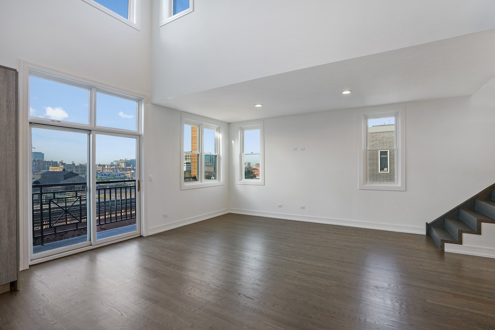 822 West Hubbard Street, Unit 5 Chicago, IL 60642 - Photo 9 of 31 an empty room with wooden floor and windows