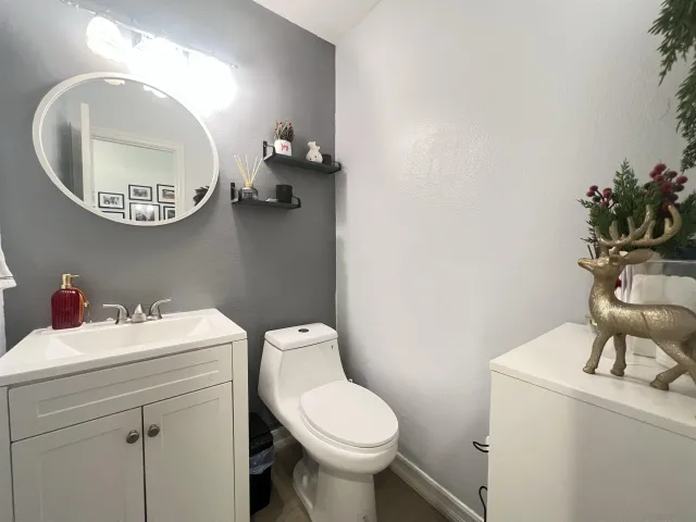 a bathroom with a sink a toilet and a mirror