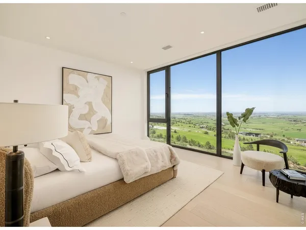 a bedroom with a bed and glass window
