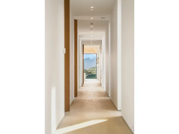 a view of a hallway with a white walls
