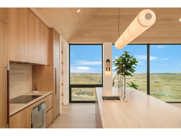 a kitchen with a refrigerator a sink and a large window