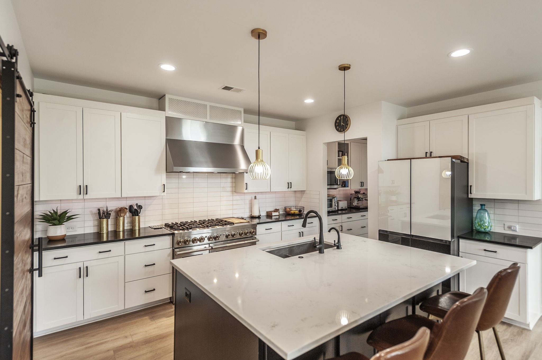 400 Quarry Road Gallatin, TN 37066 - Photo 19 of 81 a kitchen with stainless steel appliances a stove a sink a kitchen island with white cabinets and wooden floor