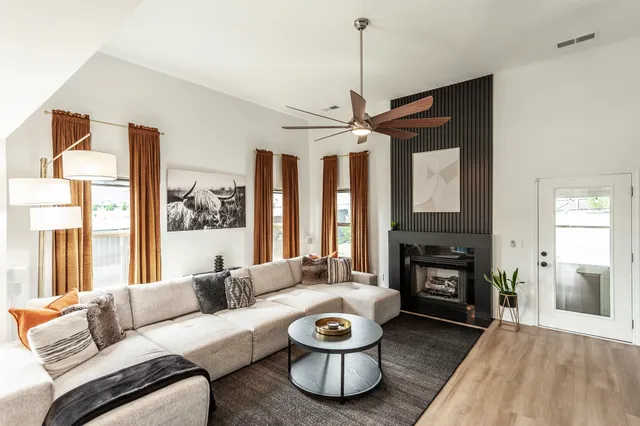 a bedroom with a bed and a ceiling fan