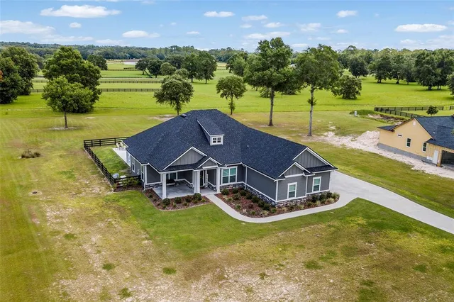 an aerial view of a house with big yard