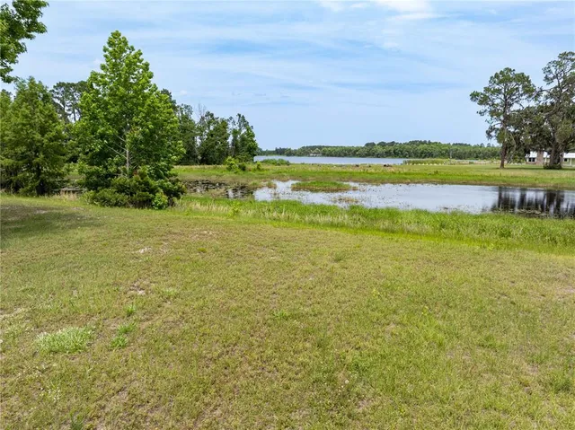 a view of a lake with houses in the back
