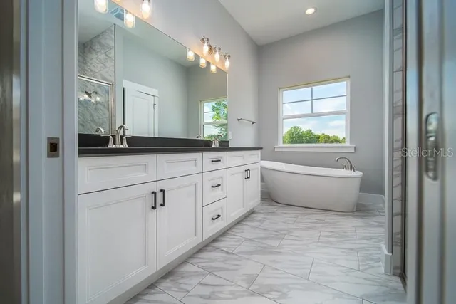 a bathroom with a granite countertop sink a toilet and a mirror