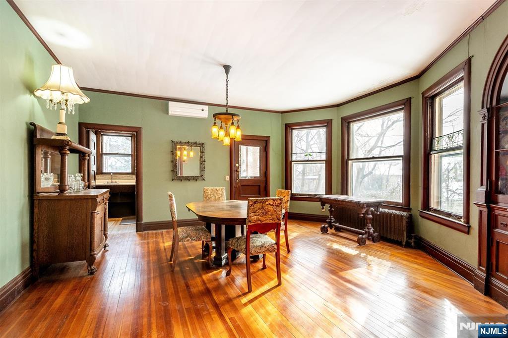 20 Prospect Terrace Montclair, NJ 07042 - Photo 15 of 49 a dining room with wooden floor a chandelier a glass table and chairs