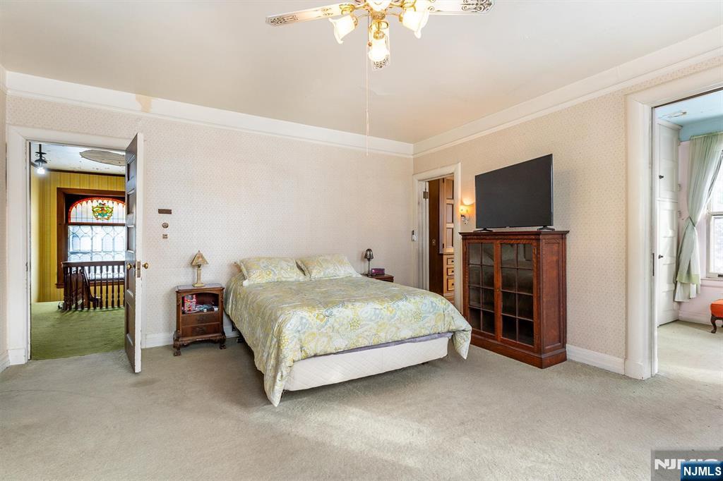 20 Prospect Terrace Montclair, NJ 07042 - Photo 28 of 49 a spacious bedroom with a bed and a flat screen tv