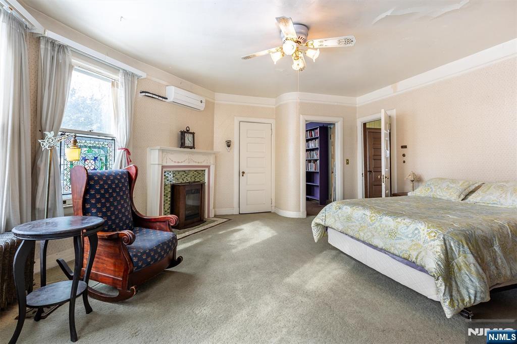20 Prospect Terrace Montclair, NJ 07042 - Photo 29 of 49 a spacious bedroom with a bed and a fireplace