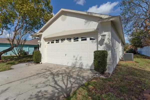 a view of a house with a yard and garage