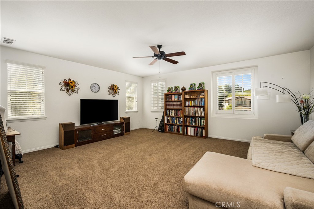12652 Twin Peak Court Riverside, CA 92503 - Photo 29 of 55 a living room with furniture and a flat screen tv