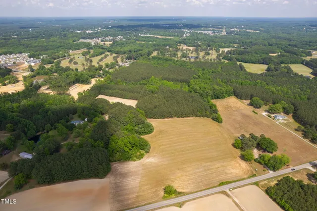 an aerial view of residential houses with outdoor space and river