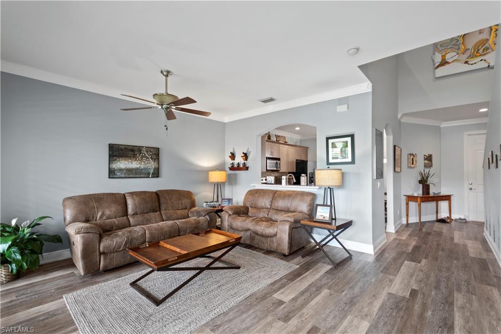 9801 Foxhall Way, Unit 5 Estero, FL 33928 - Photo 12 of 26 a living room with furniture and a wooden floor