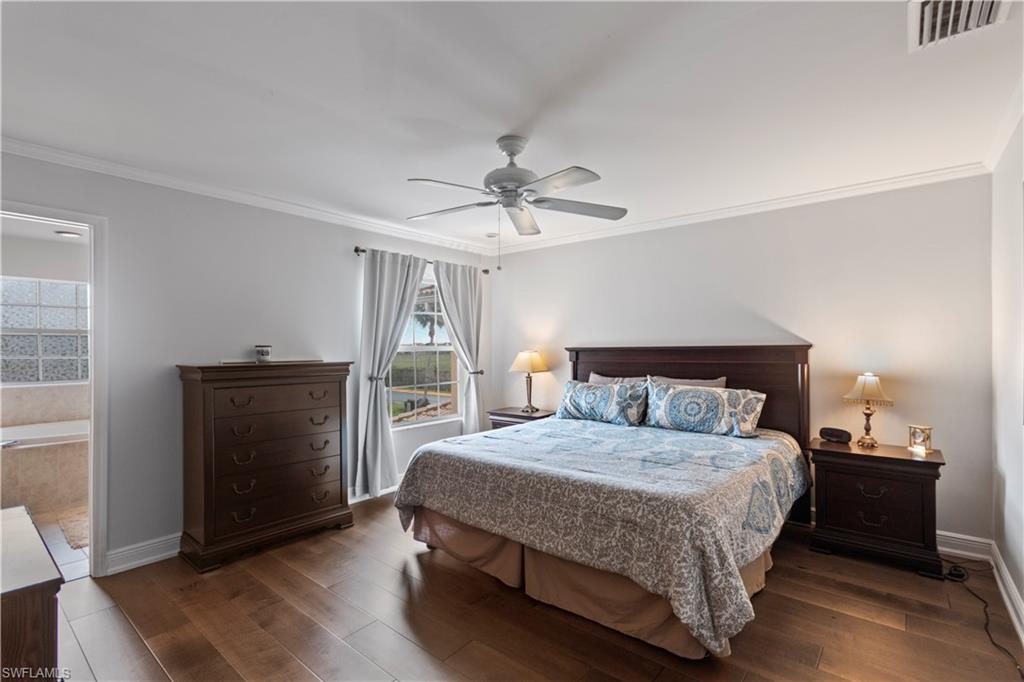 9801 Foxhall Way, Unit 5 Estero, FL 33928 - Photo 13 of 26 a bedroom with a bed and a ceiling fan