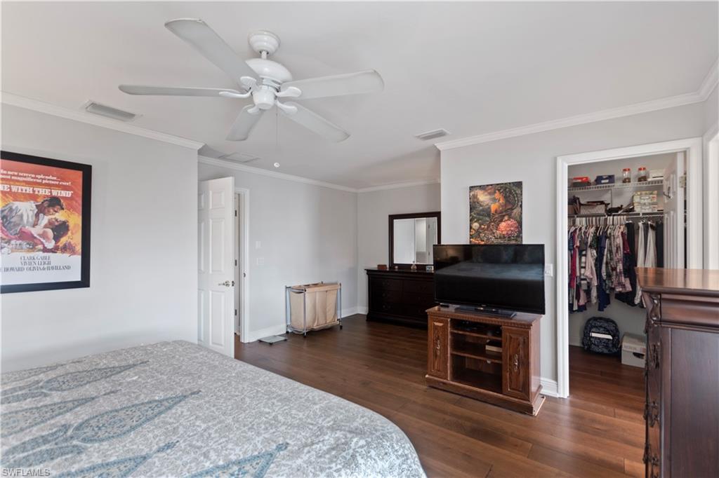 9801 Foxhall Way, Unit 5 Estero, FL 33928 - Photo 15 of 26 a bedroom with furniture and a mirror