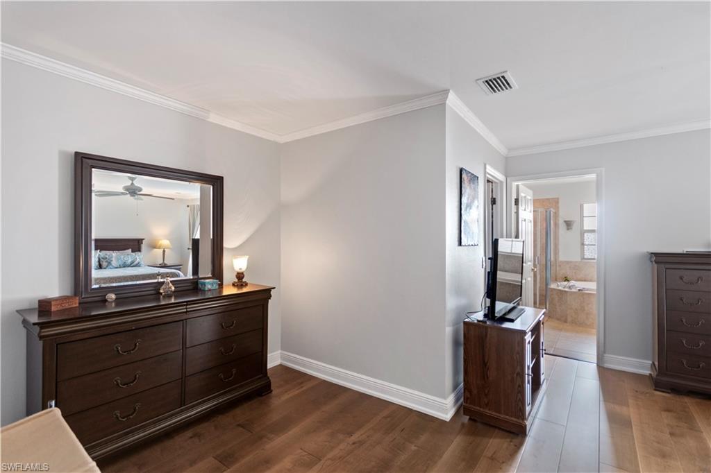 9801 Foxhall Way, Unit 5 Estero, FL 33928 - Photo 16 of 26 a living room with furniture flat screen tv and closet