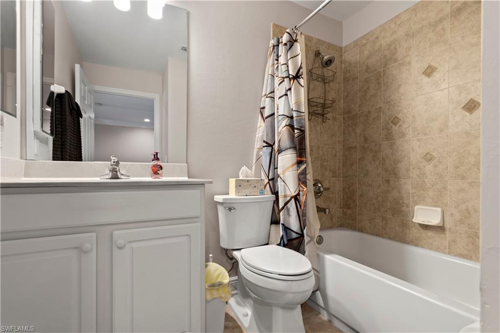 9801 Foxhall Way, Unit 5 Estero, FL 33928 - Photo 20 of 26 a bathroom with a sink a toilet and a bathtub