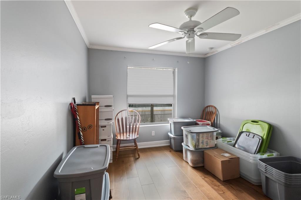 9801 Foxhall Way, Unit 5 Estero, FL 33928 - Photo 21 of 26 a living room with furniture and a chandelier
