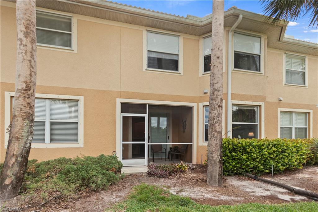 9801 Foxhall Way, Unit 5 Estero, FL 33928 - Photo 24 of 26 a front view of a house with a yard