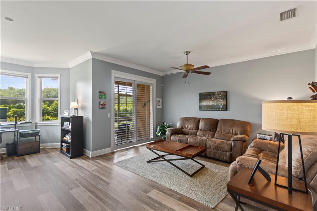 9801 Foxhall Way, Unit 5 Estero, FL 33928 - Photo 5 of 26 a living room with furniture and a window