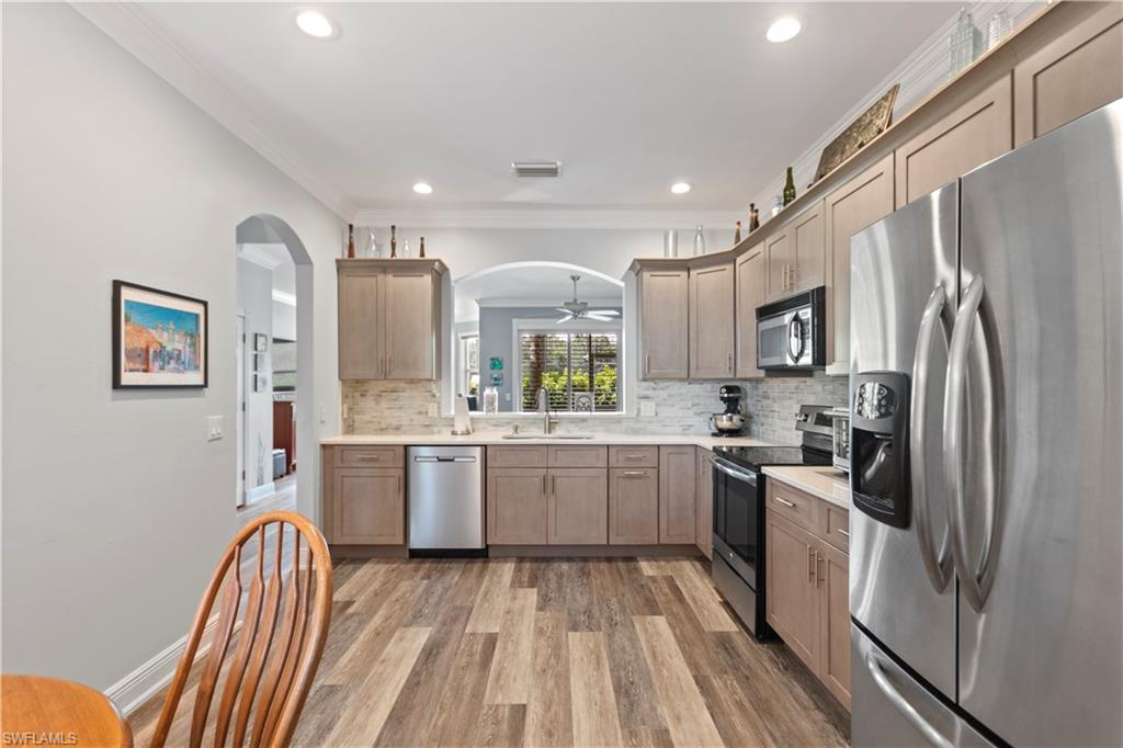 9801 Foxhall Way, Unit 5 Estero, FL 33928 - Photo 7 of 26 a kitchen with a sink appliances and cabinets