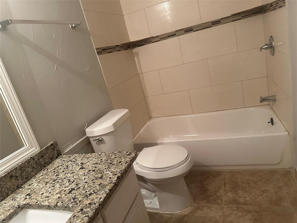 3121 Park Lane, Unit 1147 Dallas, TX 75220 - Photo 15 of 22 a white toilet sitting next to a bath tub and a shower
