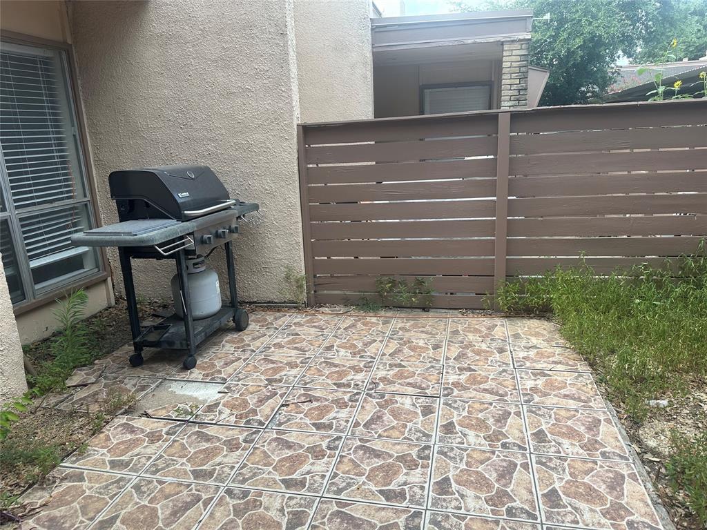 3121 Park Lane, Unit 1147 Dallas, TX 75220 - Photo 18 of 22 a view of a backyard with chair and wooden fence