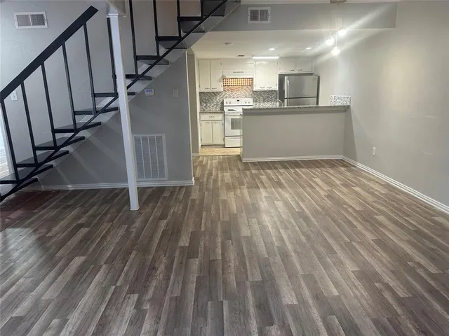 a view of kitchen and wooden floor