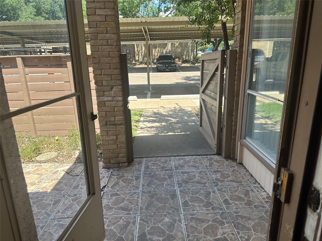 3121 Park Lane, Unit 1147 Dallas, TX 75220 - Photo 4 of 22 a view of a glass door with a tree