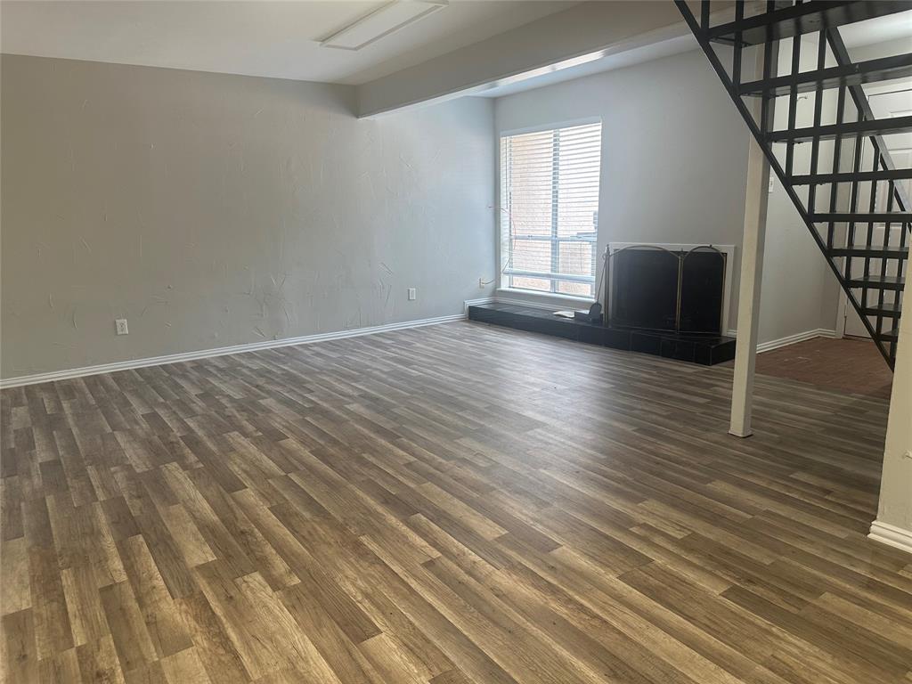 3121 Park Lane, Unit 1147 Dallas, TX 75220 - Photo 5 of 22 a view of empty room with wooden floor and fan