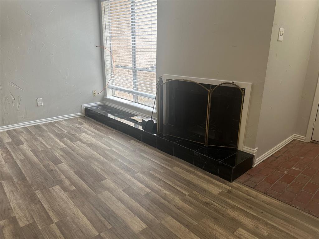 3121 Park Lane, Unit 1147 Dallas, TX 75220 - Photo 7 of 22 a view of an empty room with wooden floor and a window