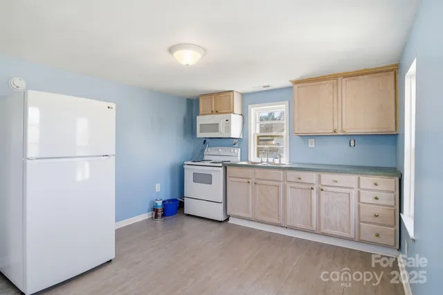 a kitchen with stainless steel appliances granite countertop a refrigerator sink and cabinets