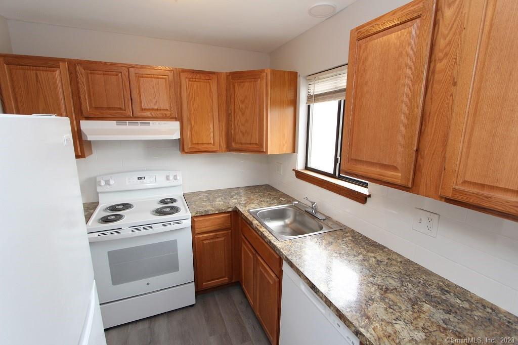 1400 Meriden Road, Unit 52 Waterbury, CT 06705 - Photo 6 of 21 a kitchen with granite countertop cabinets stainless steel appliances and a sink