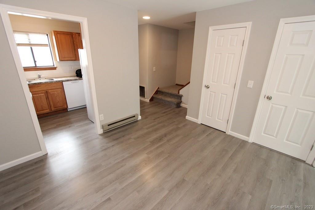1400 Meriden Road, Unit 52 Waterbury, CT 06705 - Photo 9 of 21 wooden floor in an empty room and a window